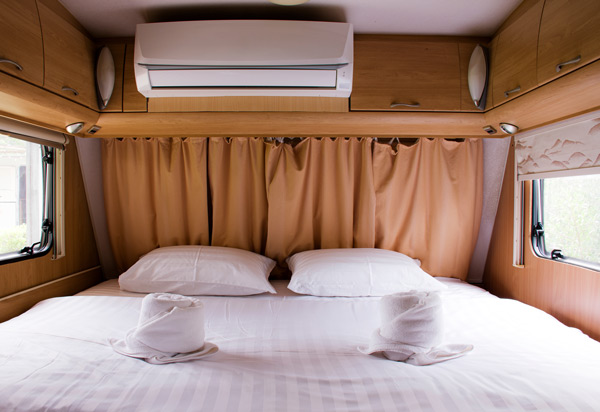 Ein großes Bett für zwei Personen in einem Wohnmobil.